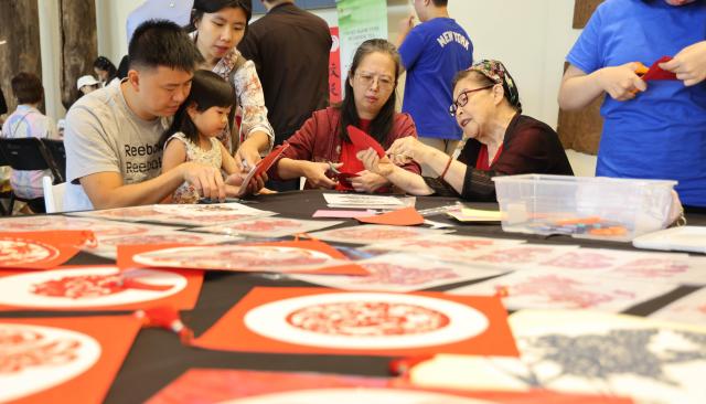 (260914) -- LOS ANGELES, Sept. 14, 2026 (Xinhua) -- People learn paper cutting during a culture event to celebrate the Mid-Autumn Festival at the Bowers Museum in Santa Ana, California, on Sept. 13, 2026. The Bowers Museum in Southern California hosted a series of cultural events on Sunday to celebrate the Mid-Autumn Festival, one of the most cherished traditional holidays in China and other parts of Asia.
  The events featured traditional Chinese music and dance performances, a Chinese fashion show, tea ceremonies, Kung Fu demonstration and face-changing performance, along with hands-on cultural activities including Chinese paper-cutting and traditional printing.
  The events also included screening of documentaries on Chinese giant pandas and white dolphins.
   Visitors enjoyed traditional mooncakes, face painting and free art projects, and had the opportunity to experience traditional Chinese attire through a photo activity. (Photo by Zeng Hui/Xinhua)