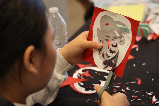 (260914) -- LOS ANGELES, Sept. 14, 2026 (Xinhua) -- A woman practices paper cutting during a culture event to celebrate the Mid-Autumn Festival at the Bowers Museum in Santa Ana, California, on Sept. 13, 2026. The Bowers Museum in Southern California hosted a series of cultural events on Sunday to celebrate the Mid-Autumn Festival, one of the most cherished traditional holidays in China and other parts of Asia.
  The events featured traditional Chinese music and dance performances, a Chinese fashion show, tea ceremonies, Kung Fu demonstration and face-changing performance, along with hands-on cultural activities including Chinese paper-cutting and traditional printing.
  The events also included screening of documentaries on Chinese giant pandas and white dolphins.
   Visitors enjoyed traditional mooncakes, face painting and free art projects, and had the opportunity to experience traditional Chinese attire through a photo activity. (Photo by Zeng Hui/Xinhua)
