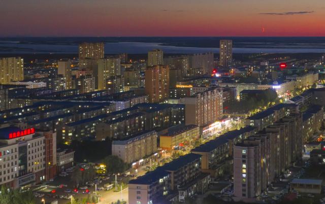 (260914) -- HARBIN, Sept. 14, 2026 (Xinhua) -- An aerial drone photo taken on Sept. 14, 2026 shows the planet of Venus next to the moon in the sky over Tongjiang City, northeast China's Heilongjiang Province. (Photo by Li Wenbin/Xinhua)