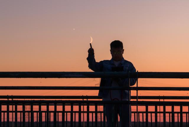 (260914) -- HARBIN, Sept. 14, 2026 (Xinhua) -- This photo taken on Sept. 14, 2026 shows the planet of Venus next to the moon in the sky over Harbin City, northeast China's Heilongjiang Province. (Photo by Liu Dapeng/Xinhua)