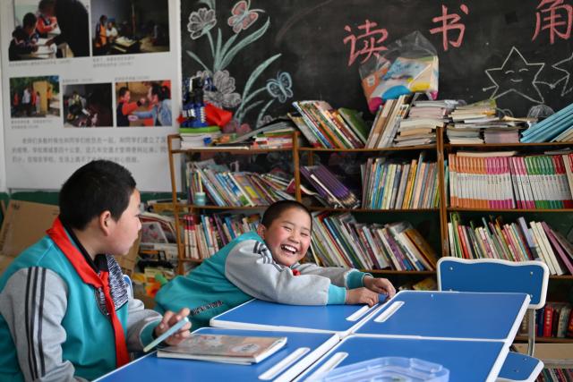 (260914) -- DATONG, Sept. 14, 2026 (Xinhua) -- Students chat after a class at Sandun Primary School in Sandun Village, Huayuantun Town of Datong, north China's Shanxi Province, Sept. 9, 2026. One day in early autumn, at Sandun Primary School at the foot of the Great Wall section built during the Ming Dynasty (1368-1644) in northern Shanxi, Yao Jian stood on the podium and gave students a lecture. Twenty-eight years have passed since the 52-year-old village teacher began his career at the school. 
  There are only seven teaching staff members and six students at Sandun Primary School, which is located on the border between north China's Shanxi Province and Inner Mongolia Autonomous Region. Tucked away in a remote area and difficult to reach, the school offers children from surrounding villages a vital path to education. 
  In 1998, Yao Jian returned to his hometown and became a teacher after graduating from normal university. Two years later, with outstanding teaching achievements, he was assigned to Sandun Primary School. In 2004, he became the principal of the school, where he also acted as chef, procurement agent and driver.
  When the school was transformed into a boarding school in 2012, he drove his car to pick up and drop off those students who lived far away in all weathers.
  Back in 2002, Yao's wife Ma Lirong moved in to support her husband and take care of these students. Later, Ma also became a teacher there. 
  "Being a teacher is a lifelong undertaking that cannot be taken lightly in the slightest," said Yao Jian. He has developed a special teaching method which combines theoretical knowledge with practice.
  In recent years, the local government has allocated various teaching equipment to the school, while welfare organizations and businesses have also brought teaching and daily necessities. "I want to be like the Great Wall, continuing to stand firm on the front line of rural education and safeguard the children's dreams of education," said Yao. (Xinhua/Hu Qiusi)