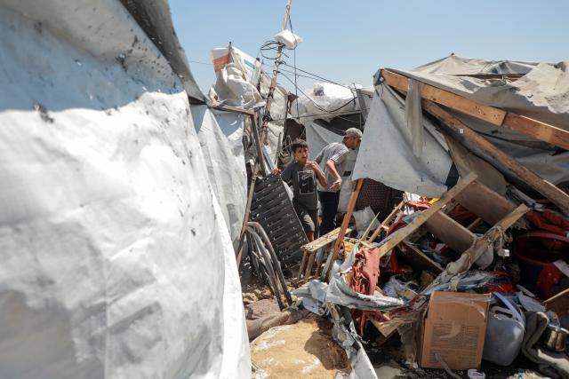 (260914) -- GAZA, Sept. 14, 2026 (Xinhua) -- Palestinians inspect a damaged tent after it was targeted by a missile fired from an Israeli drone in the al-Rimal neighborhood in central Gaza, on Sept. 14, 2026. (Photo by Rizek Abdeljawad/Xinhua)