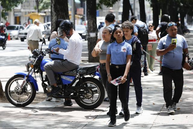 (260914) -- CARACAS, Sept. 14, 2026 (Xinhua) -- Students are pictured near a school, in Caracas, Venezuela, Sept. 14, 2026. More than 6 million Venezuelan students began the new school year on Monday, including those in La Guaira state in the country's north, which was hard hit by earthquake. (Photo by Marcos Salgado/Xinhua)