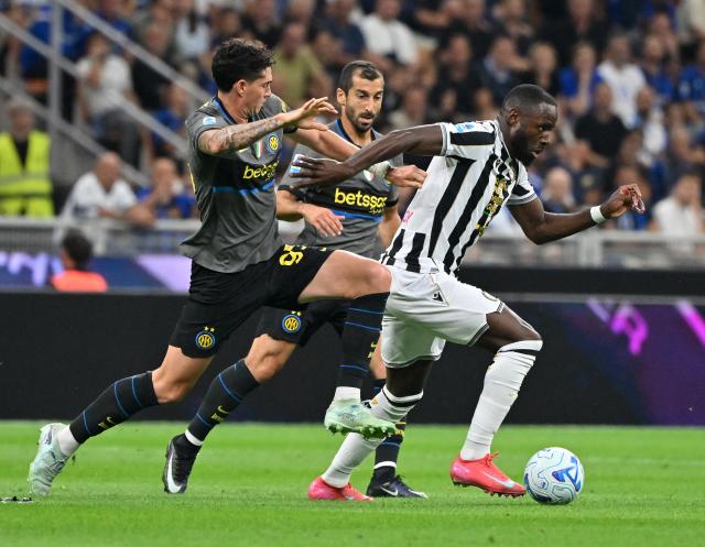 (260915) -- MILAN, Sept. 15, 2026 (Xinhua) -- Inter Milan's Alessandro Bastoni (L) and Henrikh Mkhitaryan (C) vies with Udinese's Keinan Davis during a Serie A soccer match between Inter Milan and Udinese in Milan, Italy, Sept.14, 2026. (Photo by Alberto Lingria/Xinhua)