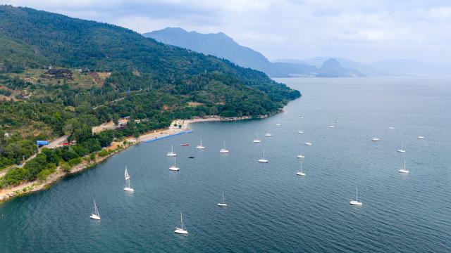 (260915) -- YUXI, Sept. 15, 2026 (Xinhua) -- An aerial drone photo taken on Sept. 14, 2026 shows the scenery of a scenic area on the west bank of Fuxian Lake in Yuxi City, southwest China's Yunnan Province. In recent years, local authorities have stepped up efforts to protect ecological environment of Fuxian Lake and developed more lakeside activities, combining the natural scenery with local fishing culture to create more consumption experiences. (Xinhua/Hu Chao)