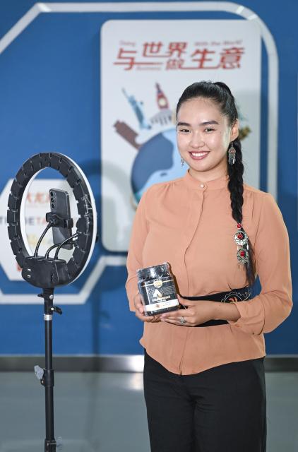(260915) -- URUMQI, Sept. 15, 2026 (Xinhua) -- Datkaiym Alparova poses for a photo at the Urumqi Bonded Exhibition and Trading Center in Urumqi, northwest China's Xinjiang Uygur Autonomous Region, Sept. 10, 2026.
  Datkaiym Alparova, who hails from Bishkek, Kyrgyzstan, is majoring in international economics and trade at Xinjiang Normal University. Entering her senior year, the 21-year-old undergraduate began receiving practical training on cross-border e-commerce livestreaming at the Urumqi Bonded Exhibition and Trading Center. 
  The center features imported goods from dozens of countries and regions. It has also provided practical training for international students, including cross-border e-commerce livestreaming, store operations and market research, said Zhang Zhaoyang, the center's new media manager. 
  "I promote honey from Kyrgyzstan to customers in Chinese via livestreaming, which makes the learning experience more immersive," Datkaiym said. Such practice has deepened her understanding of international trade. 
  Online shopping has long been part of Datkaiym's daily life. "Whether in Urumqi or Bishkek, I often buy daily items through livestream," Datkaiym said. "Many people in my hometown also use online platforms like Pinduoduo and Taobao." 
  After graduation, Datkaiym hopes to apply her professional knowledge and language skills in cross-border trade between China and Kyrgyzstan. (Xinhua/Hu Huhu)
