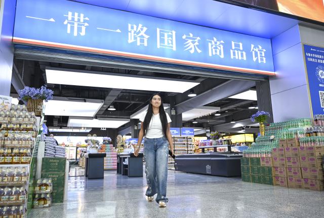 (260915) -- URUMQI, Sept. 15, 2026 (Xinhua) -- Datkaiym Alparova walks inside the Urumqi Bonded Exhibition and Trading Center in Urumqi, northwest China's Xinjiang Uygur Autonomous Region, Sept. 10, 2026.
  Datkaiym Alparova, who hails from Bishkek, Kyrgyzstan, is majoring in international economics and trade at Xinjiang Normal University. Entering her senior year, the 21-year-old undergraduate began receiving practical training on cross-border e-commerce livestreaming at the Urumqi Bonded Exhibition and Trading Center. 
  The center features imported goods from dozens of countries and regions. It has also provided practical training for international students, including cross-border e-commerce livestreaming, store operations and market research, said Zhang Zhaoyang, the center's new media manager. 
  "I promote honey from Kyrgyzstan to customers in Chinese via livestreaming, which makes the learning experience more immersive," Datkaiym said. Such practice has deepened her understanding of international trade. 
  Online shopping has long been part of Datkaiym's daily life. "Whether in Urumqi or Bishkek, I often buy daily items through livestream," Datkaiym said. "Many people in my hometown also use online platforms like Pinduoduo and Taobao." 
  After graduation, Datkaiym hopes to apply her professional knowledge and language skills in cross-border trade between China and Kyrgyzstan. (Xinhua/Hu Huhu)
