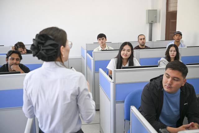 (260915) -- URUMQI, Sept. 15, 2026 (Xinhua) -- Datkaiym Alparova (2nd R, 2nd row) takes a class at Xinjiang Normal University in Urumqi, northwest China's Xinjiang Uygur Autonomous Region, Sept. 9, 2026.
  Datkaiym Alparova, who hails from Bishkek, Kyrgyzstan, is majoring in international economics and trade at Xinjiang Normal University. Entering her senior year, the 21-year-old undergraduate began receiving practical training on cross-border e-commerce livestreaming at the Urumqi Bonded Exhibition and Trading Center. 
  The center features imported goods from dozens of countries and regions. It has also provided practical training for international students, including cross-border e-commerce livestreaming, store operations and market research, said Zhang Zhaoyang, the center's new media manager. 
  "I promote honey from Kyrgyzstan to customers in Chinese via livestreaming, which makes the learning experience more immersive," Datkaiym said. Such practice has deepened her understanding of international trade. 
  Online shopping has long been part of Datkaiym's daily life. "Whether in Urumqi or Bishkek, I often buy daily items through livestream," Datkaiym said. "Many people in my hometown also use online platforms like Pinduoduo and Taobao." 
  After graduation, Datkaiym hopes to apply her professional knowledge and language skills in cross-border trade between China and Kyrgyzstan. (Xinhua/Hu Huhu)