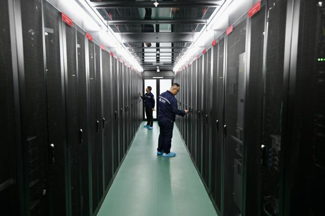 (260915) -- YINCHUAN, Sept. 15, 2026 (Xinhua) -- A staff member checks the computing power equipment at Minning Green Electricity and Digital Intelligent Application Center in Minning Town of Yinchuan, northwest China's Ningxia Hui Autonomous Region, Sept. 11, 2026. (Xinhua/Yang Zhisen)