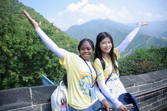 (260915) -- NAIROBI, Sept. 15, 2026 (Xinhua) -- Miriam Achieng Kenyatta (L) poses for a photo while visiting the Juyongguan section of the Great Wall in Beijing, capital of China, Aug. 5, 2026. Miriam Achieng Kenyatta, a 23-year-old geospatial engineering student at the University of Nairobi, received a warm reception upon returning home after making history at the 25th "Chinese Bridge" Chinese Proficiency Competition for Foreign College Students.
  Raised in Nairobi's Kibera informal settlement, Achieng's life trajectory was transformed by a childhood curiosity sparked by a television movie. Her passion culminated in the highest-ever ranking by a Kenyan in the prestigious global contest, where she placed among the Top 15 worldwide.
  TO GO WITH "From Kibera to world top 15: Kenyan student makes history in Chinese competition" (Xinhua)