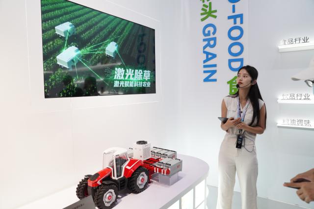 (260915) -- WUHAN, Sept. 15, 2026 (Xinhua) -- A staff member introduces the application of laser cutting in agricultural weeding at a technology company in Wuhan, central China's Hubei Province, Sept. 14, 2026. Leveraging the advanced manufacturing cluster in the Wuhan Optics Valley, key technology companies in Wuhan have driven a coordinated development of more than 100 upstream and downstream enterprises. (Xinhua/Lu Jinbo)