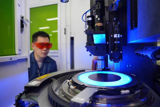 (260915) -- WUHAN, Sept. 15, 2026 (Xinhua) -- This undated file photo shows a technician of a technology company working on a high-end semiconductor wafer dicing machine in Wuhan, central China's Hubei Province. Leveraging the advanced manufacturing cluster in the Wuhan Optics Valley, key technology companies in Wuhan have driven a coordinated development of more than 100 upstream and downstream enterprises. (Xinhua)