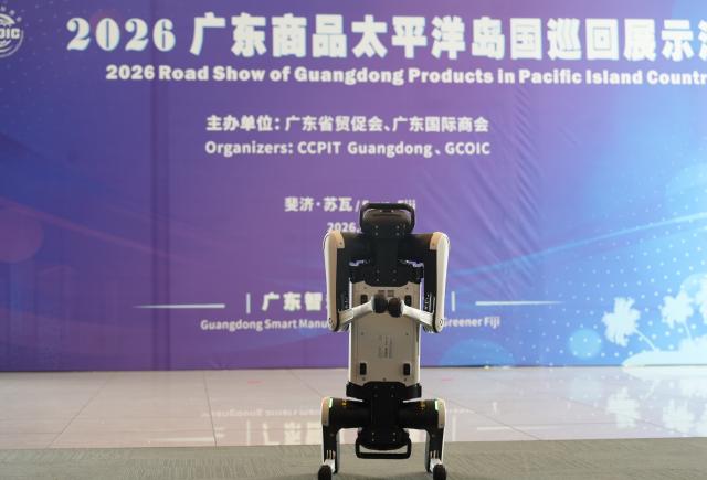 (260915) -- SUVA, Sept. 15, 2026 (Xinhua) -- A Guangdong-made AI robot dog is on display at the 2026 roadshow of Guangdong products in Pacific Island countries held in Suva, Fiji, on Sept. 15, 2026. The 2026 roadshow of Guangdong products in Pacific Island countries was held in Suva, the capital of Fiji, on Tuesday, aiming to deepen economic and trade ties between China, Fiji, and other Pacific Island countries, as well as to explore new opportunities for cooperation. (Xinhua/Bai Yongquan)