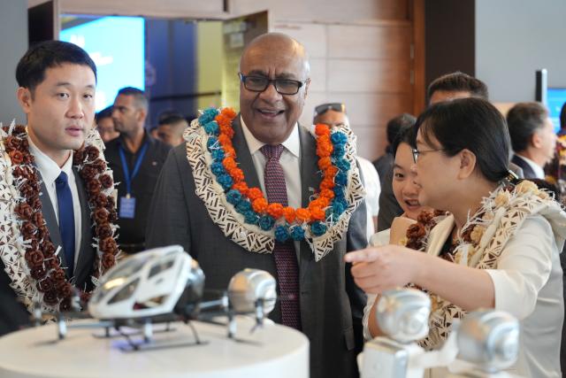 (260915) -- SUVA, Sept. 15, 2026 (Xinhua) -- Fijian Deputy Prime Minister Manoa Kamikamica learns about the exhibits at the 2026 roadshow of Guangdong products in Pacific Island countries held in Suva, Fiji, on Sept. 15, 2026. The 2026 roadshow of Guangdong products in Pacific Island countries was held in Suva, the capital of Fiji, on Tuesday, aiming to deepen economic and trade ties between China, Fiji, and other Pacific Island countries, as well as to explore new opportunities for cooperation. (Xinhua/Bai Yongquan)
