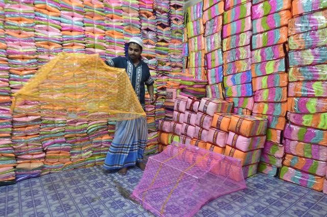 (260915) -- NARAYANGANJ, Sept. 15, 2026 (Xinhua) -- A seller works at a wholesale market for mosquito nets in Narayanganj, Bangladesh, on Sept. 14, 2026. Bangladesh has seen a rising demand for mosquito nets and other protective products amid an ongoing dengue outbreak. (Photo by Habibur Rahman/Xinhua)