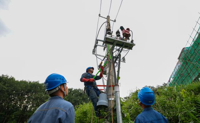 (260916) -- BEIJING, Sept. 16, 2026 (Xinhua) -- Staff members from the Hainan branch of China Southern Power Grid repair a power facility in Wuzhishan City, south China's Hainan Province, Sept. 15, 2026. As the intensity and extent of torrential rainfall decreased, Hainan has shifted to full-scale post-disaster recovery operations across the province. (Xinhua/Yang Guanyu)