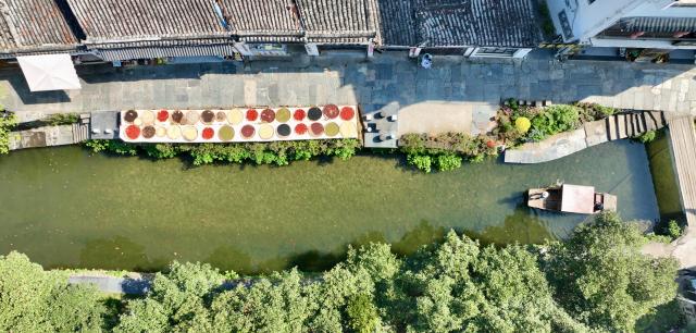 (260916) -- WUYUAN, Sept. 16, 2026 (Xinhua) -- An aerial drone photo taken on Sept. 15, 2026 shows a view of Likeng Village of Wuyuan County, east China's Jiangxi Province. In autumn, villagers are busy drying agricultural products in Wuyuan County, and the colorful scene attracts tourists. (Xinhua/Hu Chenhuan)