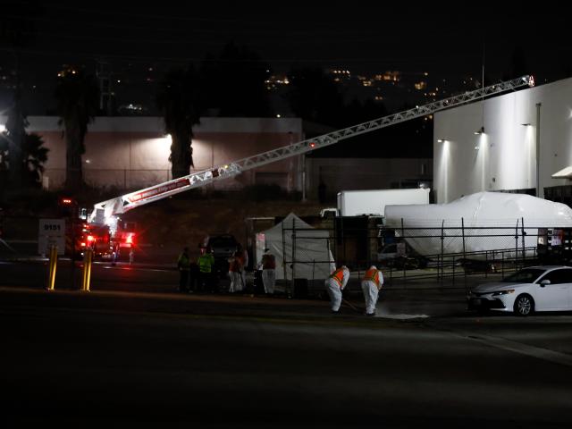 (260916) -- LOS ANGELES, Sept. 16, 2026 (Xinhua) -- Workers are seen at the site of a helicopter crash in Los Angeles, California, the United States, Sept. 16, 2026. A helicopter crashed between two commercial buildings in suburban Los Angeles on Tuesday night, killing at least three people, local authorities said. (Photo by Qiu Chen/Xinhua)
