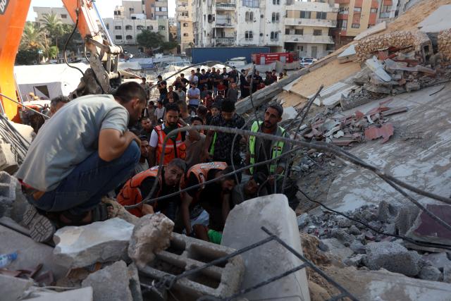 (260916) -- GAZA, Sept. 16, 2026 (Xinhua) -- Palestinian civil defense crews search for bodies and survivors in the rubble of a collapsed building that housed displaced Palestinians in Gaza City, Sept. 16, 2026. The death toll from the collapse of a residential building in western Gaza City rose to 21, including 11 children and six women, with more than 25 injured, local officials and residents said Wednesday. (Photo by Rizek Abdeljawad/Xinhua)