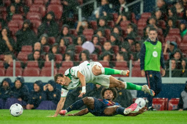(260917) -- BARCELONA, Sept. 17, 2026 (Xinhua) -- FC Barcelona's Karim Adeyemi (bottom) vies with Racing Santander's Sergio Canales during the La Liga football match between FC Barcelona and Racing Santander in Barcelona, Spain, on Sept. 16, 2026. (Photo by Joan Gosa/Xinhua)