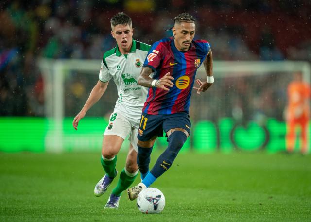 (260917) -- BARCELONA, Sept. 17, 2026 (Xinhua) -- FC Barcelona's Raphinha (R) vies with Racing Santander's Inigo Sainz during the La Liga football match between FC Barcelona and Racing Santander in Barcelona, Spain, on Sept. 16, 2026. (Photo by Joan Gosa/Xinhua)
