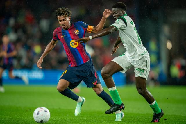 (260917) -- BARCELONA, Sept. 17, 2026 (Xinhua) -- FC Barcelona's Lamine Yamal (L) vies with Racing Santander's Maguette Gueye during the La Liga football match between FC Barcelona and Racing Santander in Barcelona, Spain, on Sept. 16, 2026. (Photo by Joan Gosa/Xinhua)