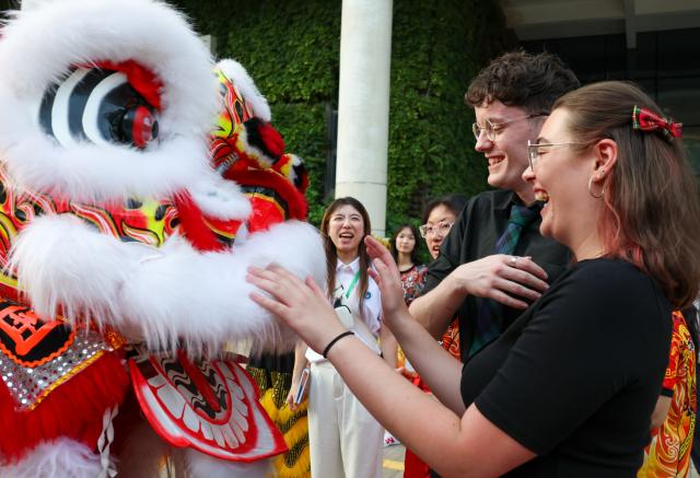 (260917) -- BEIJING, Sept. 17, 2026 (Xinhua) -- Members of a youth band from Britain interact with lion dance performers during the 2026 International Youth Band China Tour (Shenzhen) in Shenzhen, south China's Guangdong Province, Sept. 16, 2026. The tour kicked off here on Wednesday. (Xinhua/Mao Siqian)