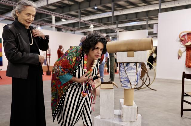 (260917) -- RIO DE JANEIRO, Sept. 17, 2026 (Xinhua) -- Visitors look at an art installation during the ArtRio 2026 in Rio de Janeiro, Brazil, Sept. 16, 2026. The five-day fair kicked off here on Wednesday, showcasing contemporary artworks such as paintings, sculptures and art installations from around the world. (Xinhua/Jin Haoyuan)