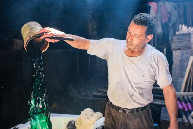 (260917) -- CAIRO, Sept. 17, 2026 (Xinhua) -- A craftsman adds dye to the dye vat at a traditional dyehouse in Cairo, Egypt, Sept. 16, 2026. Established in 1901, Uncle Salama's Dyehouse is among the few remaining traditional dye houses in Egypt. As industrial textile production has expanded, such workshops have become increasingly rare. (Xinhua/Xin Mengchen)