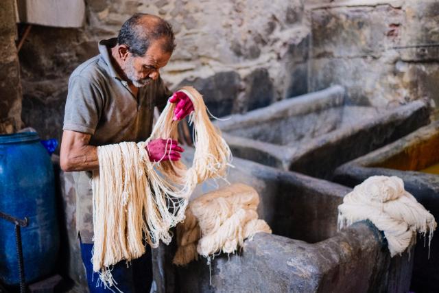 (260917) -- CAIRO, Sept. 17, 2026 (Xinhua) -- A craftsman sorts skeins of yarn at a traditional dyehouse in Cairo, Egypt, Sept. 16, 2026. Established in 1901, Uncle Salama's Dyehouse is among the few remaining traditional dye houses in Egypt. As industrial textile production has expanded, such workshops have become increasingly rare. (Xinhua/Xin Mengchen)