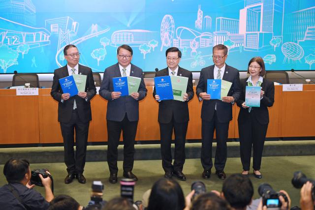 (260917) -- HONG KONG, Sept. 17, 2026 (Xinhua) -- John Lee (C), chief executive of the Hong Kong Special Administrative Region (HKSAR), holding a copy of Hong Kong's first five-year plan for economic and social development (2026-2030) and a copy of chief executive's 2026 policy address, poses for a group photo with Chan Kwok-ki (2nd L), Chief Secretary for Administration of the HKSAR government, Paul Chan Mo-po (2nd R), Financial Secretary of the HKSAR government, Paul Lam (1st L), Secretary for Justice of the HKSAR government, and Janice Tse Siu-wa, Secretary for Constitutional and Mainland Affairs of the HKSAR government, in south China's Hong Kong, Sept. 16, 2026. TO GO WITH "Roundup: Hong Kong unveils maiden 5-year plan, charts roadmap for high-quality development" (Xinhua/Chen Duo)