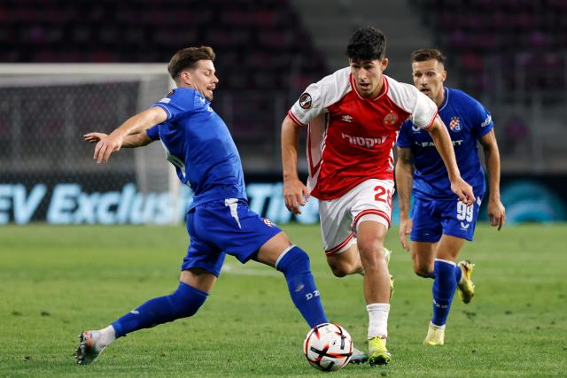 (260917) -- BUCHAREST, Sept. 17, 2026 (Xinhua) -- Hapoel Beer-Sheva's Niv Yehoshuha (C) vies with GNK Dinamo's Miha Zajc (L) during the UEFA Europa League football match between Hapoel Beer-Sheva and GNK Dinamo in Bucharest, Romania, Sept. 16, 2026. (Photo by Cristian Cristel/Xinhua)