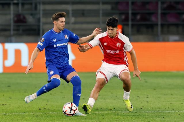 (260917) -- BUCHAREST, Sept. 17, 2026 (Xinhua) -- Hapoel Beer-Sheva's Niv Yehoshuha (R) vies with GNK Dinamo's Miha Zajc during the UEFA Europa League football match between Hapoel Beer-Sheva and GNK Dinamo in Bucharest, Romania, Sept. 16, 2026. (Photo by Cristian Cristel/Xinhua)