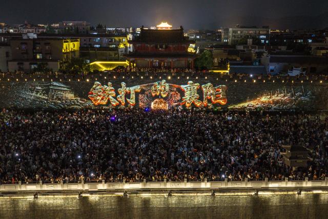(260917) -- XIANGYANG, Sept. 17, 2026 (Xinhua) -- A drone photo taken on Sept. 12, 2026 shows people enjoying a light show at Xiangyang ancient town in Xiangyang, central China's Hubei Province. In recent years, Xiangyang in central China's Hubei Province has been promoting tourism through light shows, evening cruises, live performances and night markets. The city has also integrated its historical and cultural heritage into tourism, offering visitors a richer experience that blends local history with vibrant street life. (Photo by Yang Dong/Xinhua)
