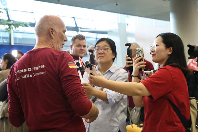 (260917) -- SHANGHAI, Sept. 17, 2026 (Xinhua) -- A member of German delegation for the 48th WorldSkills Competition receives an interview upon his arrival at Shanghai Pudong International Airport in Shanghai, east China, Sept. 17, 2026. The 48th WorldSkills Competition is scheduled to take place from September 22 to 27 in Shanghai. (Xinhua/Fang Zhe)