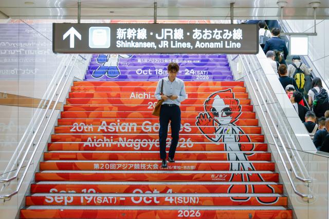 (260917) -- NAGOYA, Sept. 17, 2026 (Xinhua) -- A man walks down stairs with decorations for the 20th Asian Games Aichi-Nagoya 2026 at Nagoya Station in Nagoya, Japan, Sept. 17, 2026. (Xinhua/Wu Zhizun)