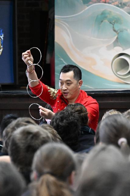 (260917) -- GEELONG, Sept. 17, 2026 (Xinhua) -- A Chinese magician performs during a Chinese Culture Day event at Geelong College in Australia, Sept. 16, 2026. TO GO WITH "Feature: Chinese Culture Day brings China closer to Australian students" (Xinhua/Xu Haijing)