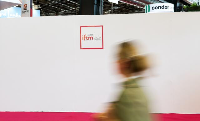 (260917) -- PARIS, Sept. 17, 2026 (Xinhua) -- A visitor passes the logo of the International & French Travel Market (IFTM) in Paris, France, Sept. 17, 2026. The three-day IFTM, an international tourism trade show, concluded in Paris on Thursday. (Xinhua/Wu Huiwo)