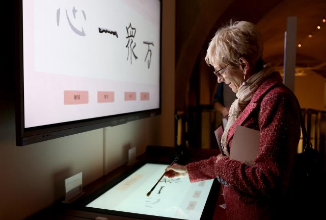 (260917) -- LONDON, Sept. 17, 2026 (Xinhua) -- A woman visits an exhibition titled "Reviving Craft: Reflection of the Mind," in London, Britain, Sept. 17, 2026. An exhibition bringing together Chinese intangible cultural heritage and contemporary design opened at Somerset House in London on Wednesday, featuring nearly 150 works and sets of works by more than 70 Chinese and international artists.
Titled "Reviving Craft: Reflection of the Mind," the exhibition is part of the 2026 London Design Festival and runs until Sept. 27. It features works in ceramics, lacquer, embroidery, glass, fiber art, furniture and installation. (Xinhua/Li Ying)