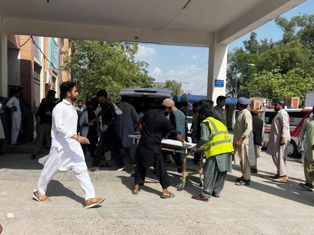 (260918) -- KOHAT, Sept. 18, 2026 (Xinhua) -- This photo taken with mobile phone shows rescuers transferring injured people to the hospital at Kohat in Pakistan's Khyber Pakhtunkhwa province on Sept. 18, 2026. At least 16 people were killed and over 50 others injured in a twin suicide attack inside a residential compound of police in Pakistan's Khyber Pakhtunkhwa province on Friday, police and rescue officials said. (Str/Xinhua)