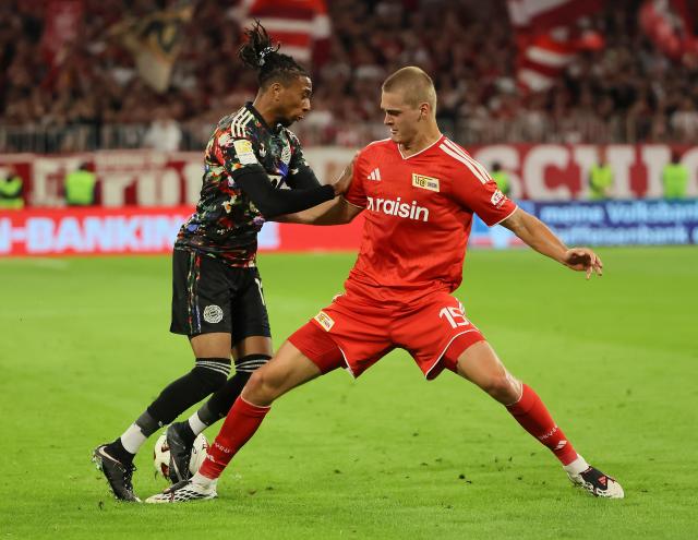 (260919) -- MUNICH, Sept. 19, 2026 (Xinhua) -- Michael Olise (L) of Bayern Munich vies with Tom Rothe of 1. FC Union Berlin during the German first division Bundesliga football match between FC Bayern Munich and 1. FC Union Berlin in Munich, Germany, Sept. 18, 2026. (Photo by Philippe Ruiz/Xinhua)