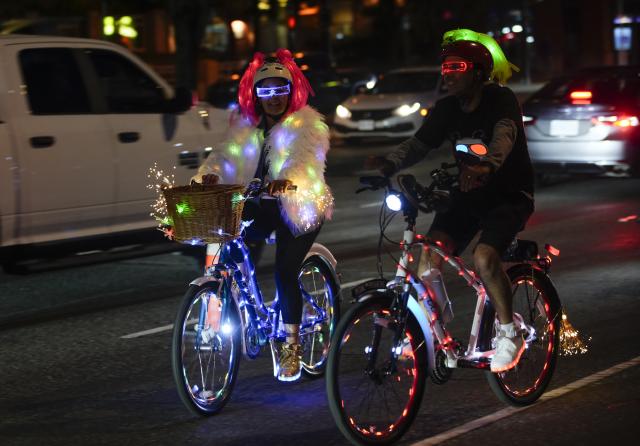 (260919) -- VANCOUVER, Sept. 19, 2026 (Xinhua) -- Cyclists ride along a street on decorated bicycles during the Bike the Night event in Vancouver, British Columbia, Canada, Sept. 18, 2026. The 10-kilometer night cycling event was held here on Friday. (Photo by Liang Sen/Xinhua)