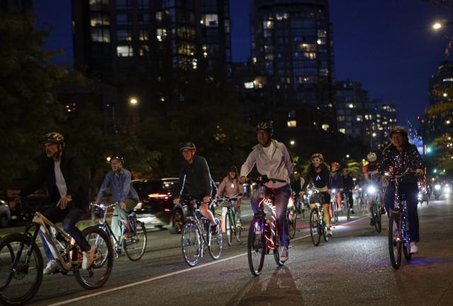 (260919) -- VANCOUVER, Sept. 19, 2026 (Xinhua) -- Cyclists ride along a street on decorated bicycles during the Bike the Night event in Vancouver, British Columbia, Canada, Sept. 18, 2026. The 10-kilometer night cycling event was held here on Friday. (Photo by Liang Sen/Xinhua)