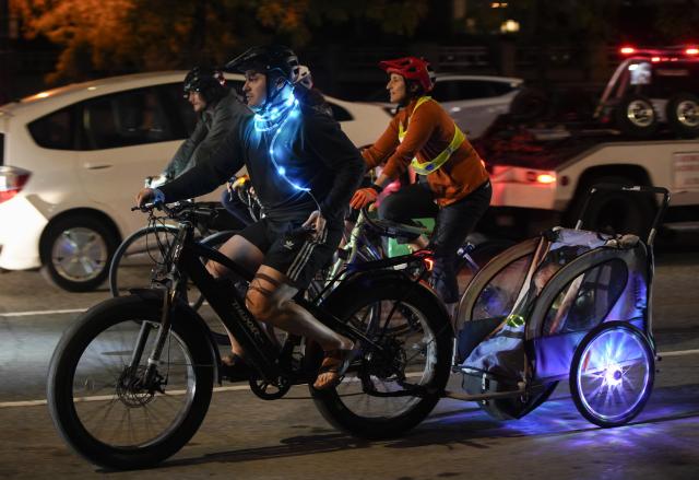 (260919) -- VANCOUVER, Sept. 19, 2026 (Xinhua) -- Cyclists ride along a street on decorated bicycles during the Bike the Night event in Vancouver, British Columbia, Canada, Sept. 18, 2026. The 10-kilometer night cycling event was held here on Friday. (Photo by Liang Sen/Xinhua)