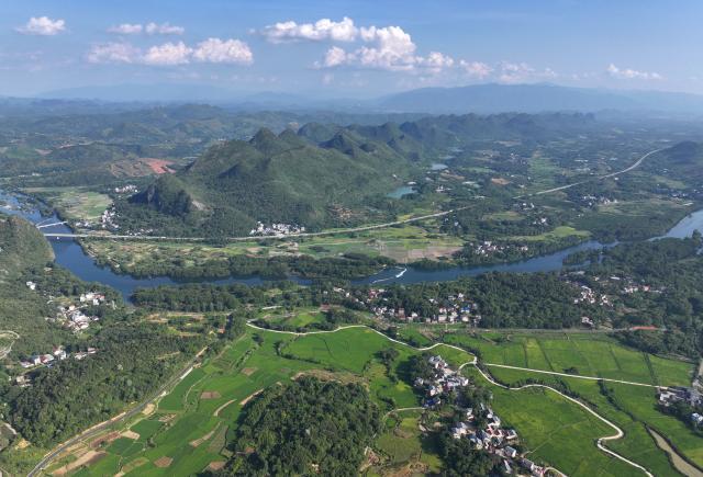 (260919) -- GUILIN, Sept. 19, 2026 (Xinhua) -- An aerial drone photo taken on Aug. 11, 2026 shows a view of the Xiangjiang River in Caiwan Town of Quanzhou County of Guilin City, south China's Guangxi Zhuang Autonomous Region. In the winter of 1934 during the Long March, the Red Army fought its way across the Xiangjiang River in Guangxi and broke through the Kuomintang troops' blockade, but suffered tens of thousands of casualties in the battle.
   In Quanzhou, Guanyang and Xing'an counties, where the Battle of the Xiangjiang River was fought, the spirit of the Long March has been passed down through generations. Today, roads wind through mountains that Red Army soldiers once crossed on foot, connecting once-isolated villages with the outside world. Local people keep striving on the path of rural revitalization. (Xinhua/Huang Xiaobang)