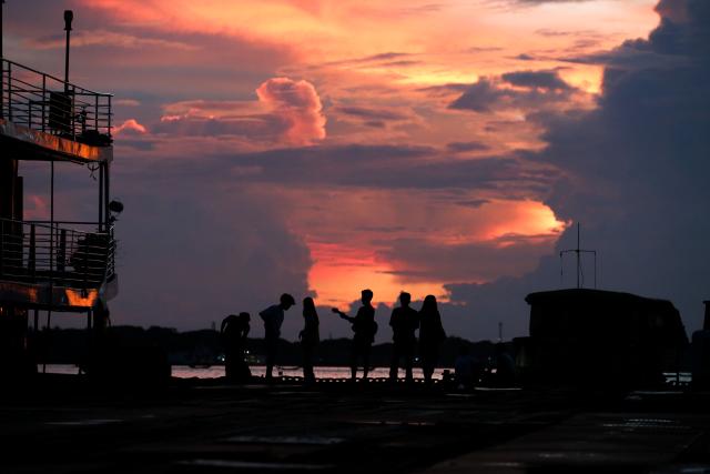 (260919) -- YANGON, Sept. 19, 2026 (Xinhua) -- People watch the sunset at Botahtaung Harbour in Yangon, Myanmar, Sept. 18, 2026. (Xinhua/Myo Kyaw Soe)