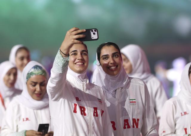 (260919) -- NAGOYA, Sept. 19, 2026 (Xinhua) -- Members of the delegation of Iran take selfies while parading into the stadium during the opening ceremony of the 20th Asian Games Aichi-Nagoya 2026 in Nagoya, Japan, Sept. 19, 2026. (Xinhua/Jia Haocheng)