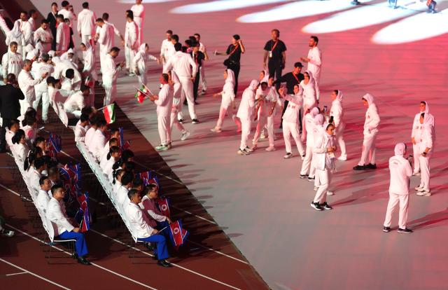 (260919) -- NAGOYA, Sept. 19, 2026 (Xinhua) -- Members of the delegation of Iran (R) and the Democratic People's Republic of Korea attend the opening ceremony of the 20th Asian Games Aichi-Nagoya 2026 in Nagoya, Japan, Sept. 19, 2026. (Xinhua/Lui Siu Wai)