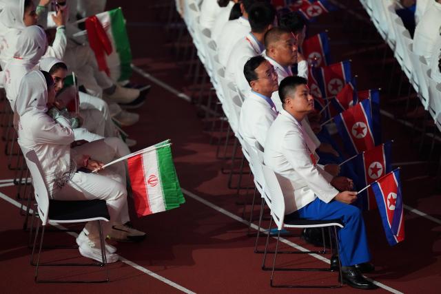 (260919) -- NAGOYA, Sept. 19, 2026 (Xinhua) -- Members of the delegation of Iran (L) and DPRK (the Democratic People's Republic of Korea) attend the opening ceremony of the 20th Asian Games Aichi-Nagoya 2026 in Nagoya, Japan, Sept. 19, 2026. (Xinhua/Lui Siu Wai)