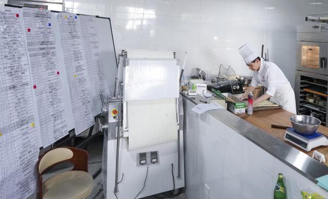 (260919) -- SUZHOU, Sept. 19, 2026 (Xinhua) -- Hou Jinchen makes bread based on his training plan at Suzhou Wuzhong Technician College in Suzhou, east China's Jiangsu Province, Aug. 27, 2026. Born in 2005, Hou Jinchen studies culinary arts at Suzhou Wuzhong Technician College. He began learning to bake at the age of 12, and his passion for it has grown ever since.
   From shaping dough to baking and decorating bread, Hou follows a rigorous training routine. He practices the same techniques over and over to build muscle memory, carefully recording changes in temperature and ingredient quantities during each session and constantly refining the details.
   Outside training, he also visits local bakeries to learn from working bakers. He believes they have a better understanding of consumer preferences, which gives him insights that training focused solely on competitions may not always provide.
   His efforts have earned him both gold and bronze medals in national vocational skills competitions, and he was later selected for the national team. The 21-year-old is now preparing for the upcoming WorldSkills Competition in Shanghai.
   Among all the competition tasks, Hou devotes particular attention to artistic bread design. From sketching ideas to making molds and baking the final pieces, the process requires repeated adjustments. He sometimes uses 3D-printed molds and plans to incorporate more Chinese elements into his competition pieces in Shanghai.
   For Hou, baking is not just a technical skill, but also a pursuit of craftsmanship. He hopes to showcase the skills and dedication of young Chinese bakers on the international stage.
   "I can't imagine leaving the baking industry," Hou said. "In the future, I hope to become a coach and pass on what I have learned to younger bakers." (Xinhua/Li Bo)